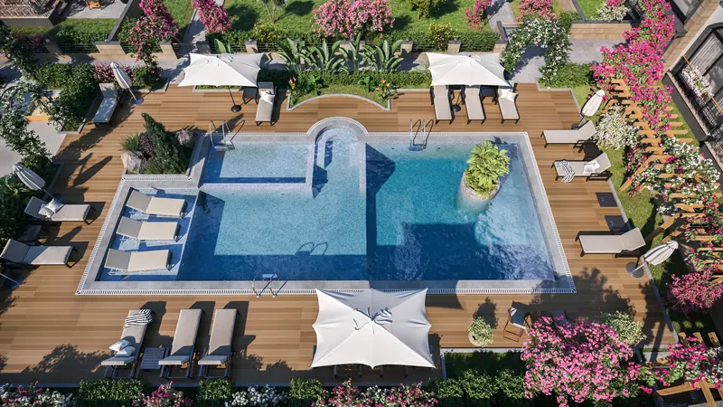 The pool and children's pool from above, with sun loungers and parasols on the timber deck