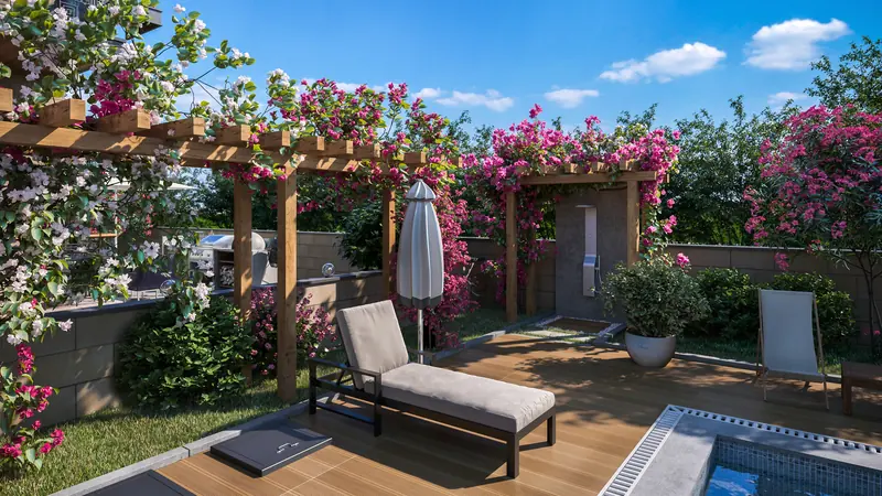 Private garden with a timber pergola, sun lounger, outdoor shower and barbecue area, enclosed by a stone wall and bougainvillea