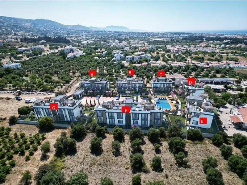 Aerial view of the site with the seven blocks labelled A to G