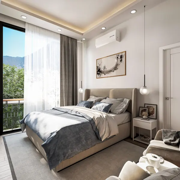 Double bedroom with full-height glazing to a balcony and mountain views beyond